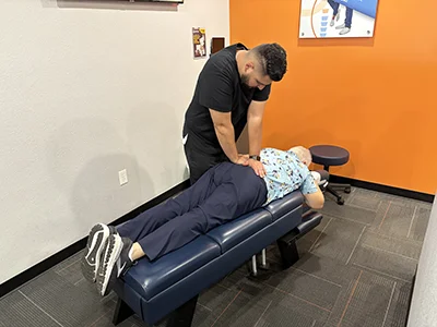 Dr. Juan Alvarez adjusting a patient's lower back