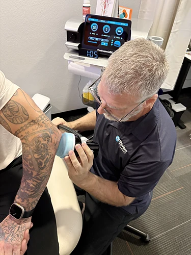 Shockwave Therapy on Patient's Elbow