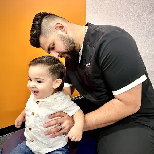Chiropractor Phoenix AZ Juan Alvarez Baby Adjustment HP Dr. Juan Alvarez adjusting a baby